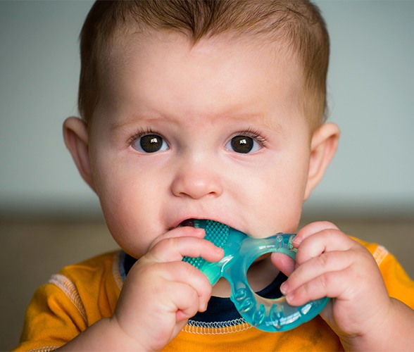 Child chewing on teething ring